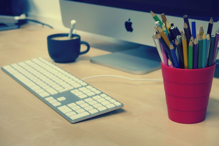 Dosarul de admitere în două săptămâni, între apeluri și e-mailuri Femeie care lucrează la laptop, cu mape și acte așezate pe birou