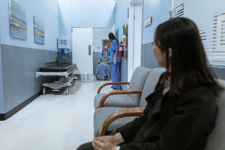 Greșeli mici care fac o investigație imagistică mai scumpă Pacient care așteaptă pe un hol de clinică, cu un dosar în mână